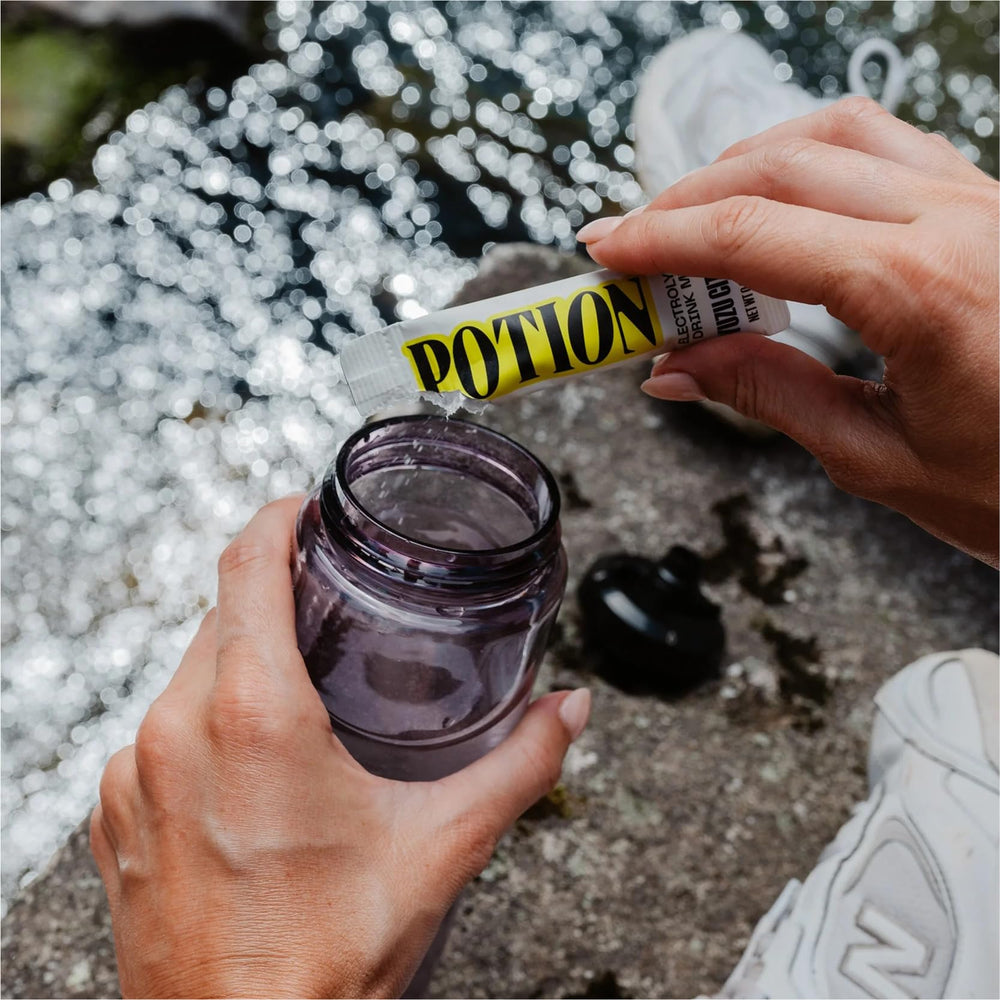 Potion Supernatural Hydration glass with drink highlights a crisp, clean hydration moment.