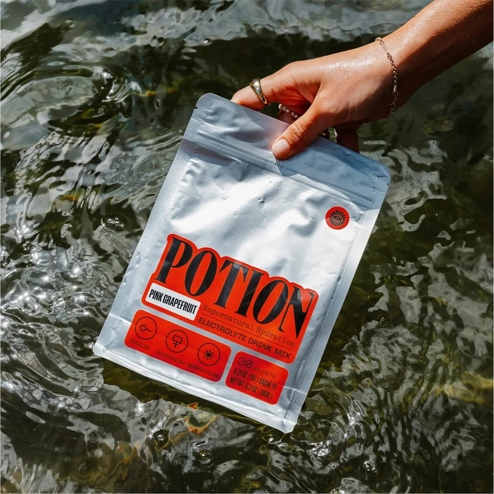 Potion Supernatural Hydration pink grapefruit pour demonstrates convenient mixing after workouts.