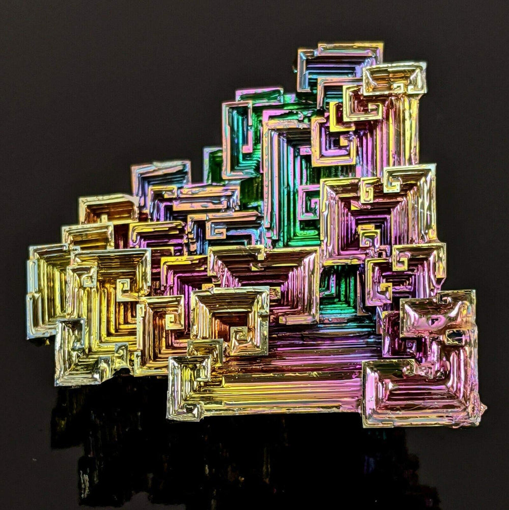 Pounique Bismuth crystal shown as decorative display or study piece.