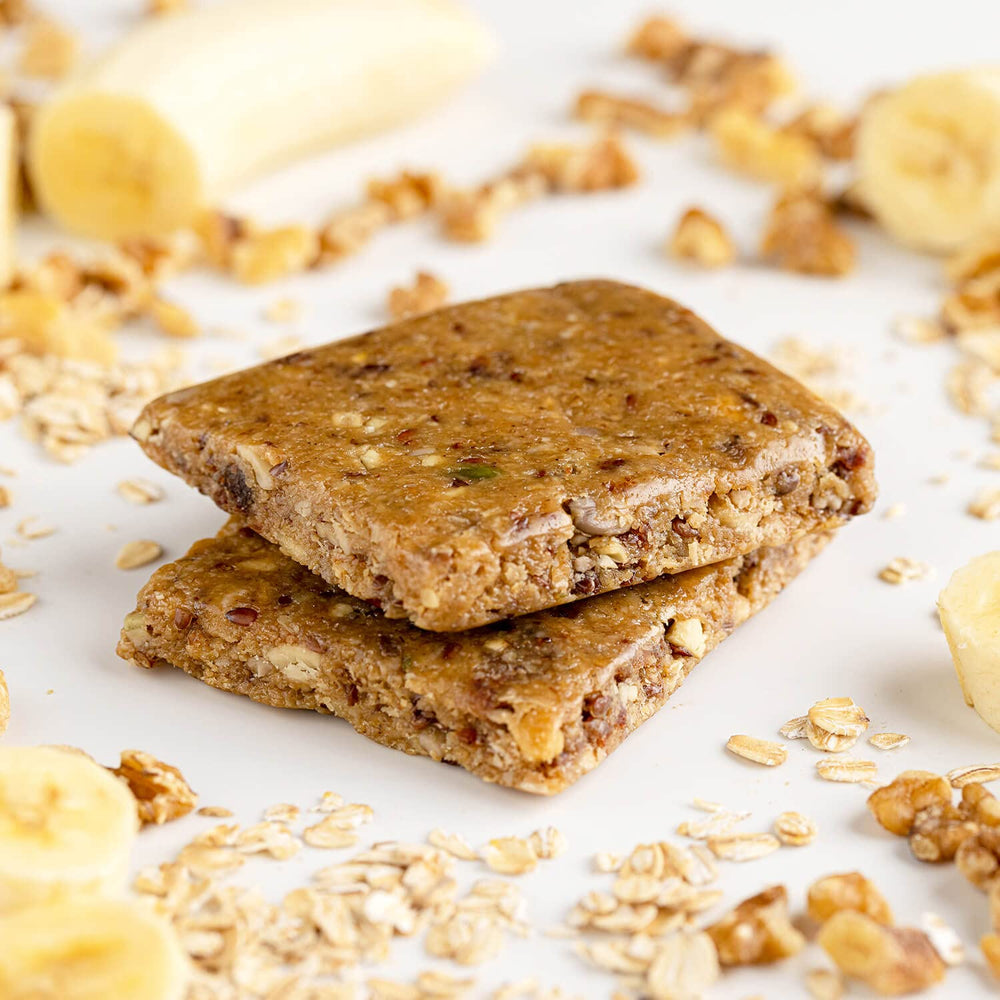 PROBAR Meal Bar Banana Nut Bread bar cross-section reveals oats and nuts.