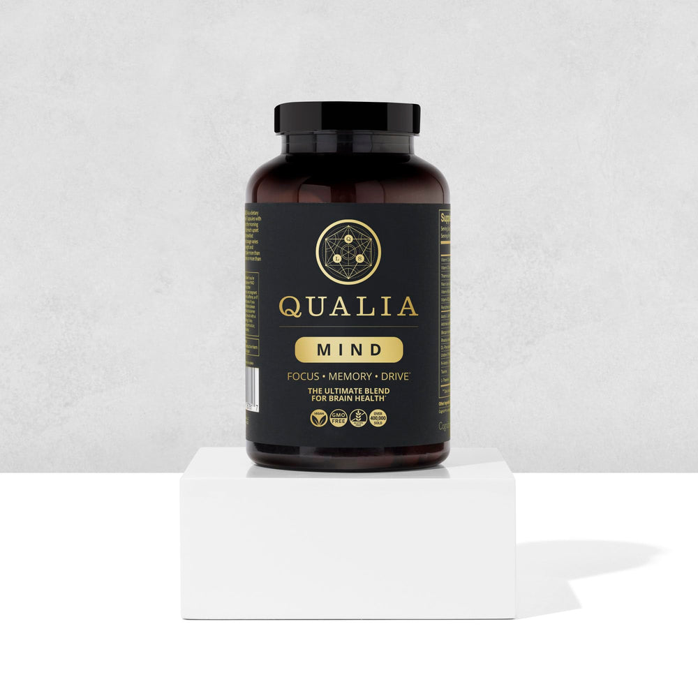 Qualia Mind capsules arranged neatly for daily routines.