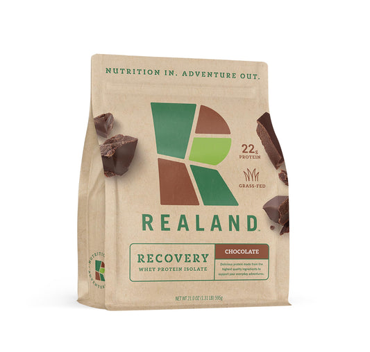 Realand Recovery Whey Isolate chocolate bottle emphasizes fast-absorption for post-workout recovery.