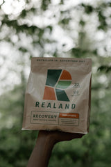 Realand whey protein isolate container with minimalist branding