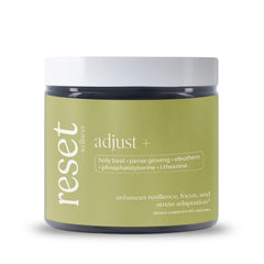 Reset Wellness Adjust+ bottle demonstrates premium adaptogen blend for stress support.