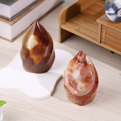 Rockcloud Carnelian Flame Tower on its smooth base for stable display.