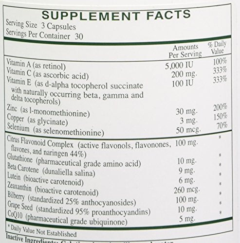 Rx Vitamins Ocular Formula bottle on desk beside reading glasses for daily eye support