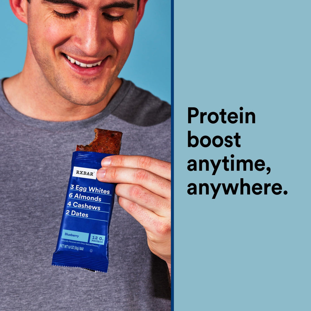 RXBAR Blueberry bar in hand during a quick break