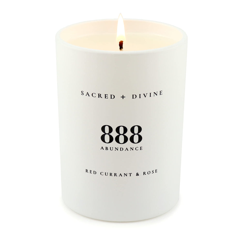 Sacred + Divine 888 abundance candle jar surface showing minimalist design.