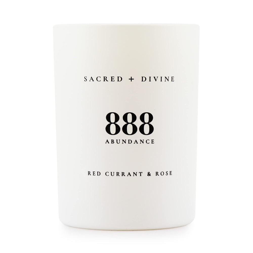Sacred + Divine 888 abundance candle label close-up for mindful intention setting.