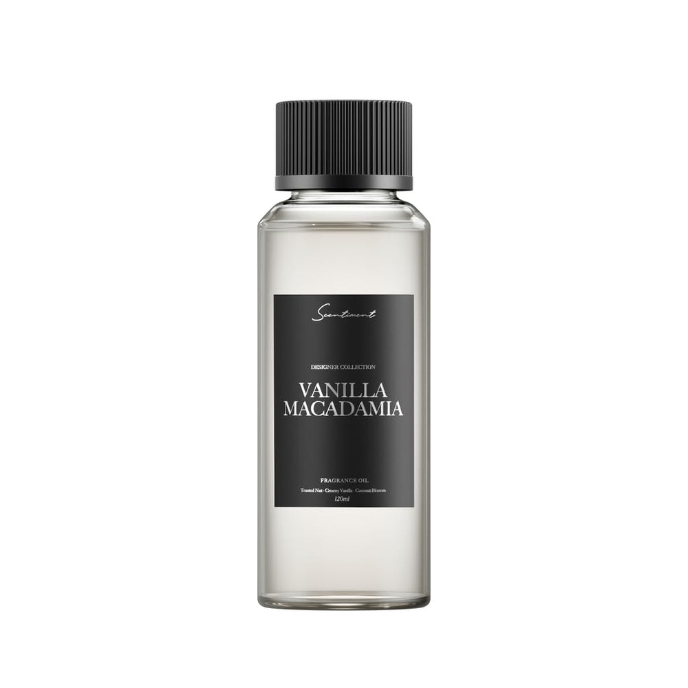 Scentiment Vanilla Macadamia diffuser oil bottle being poured for a cozy room