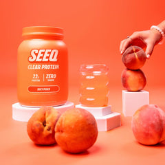 SEEQ Juicy Peach powder being poured into water for a light, refreshing shake.
