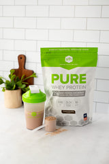 Canister with spoon ready for serving SFH chocolate protein