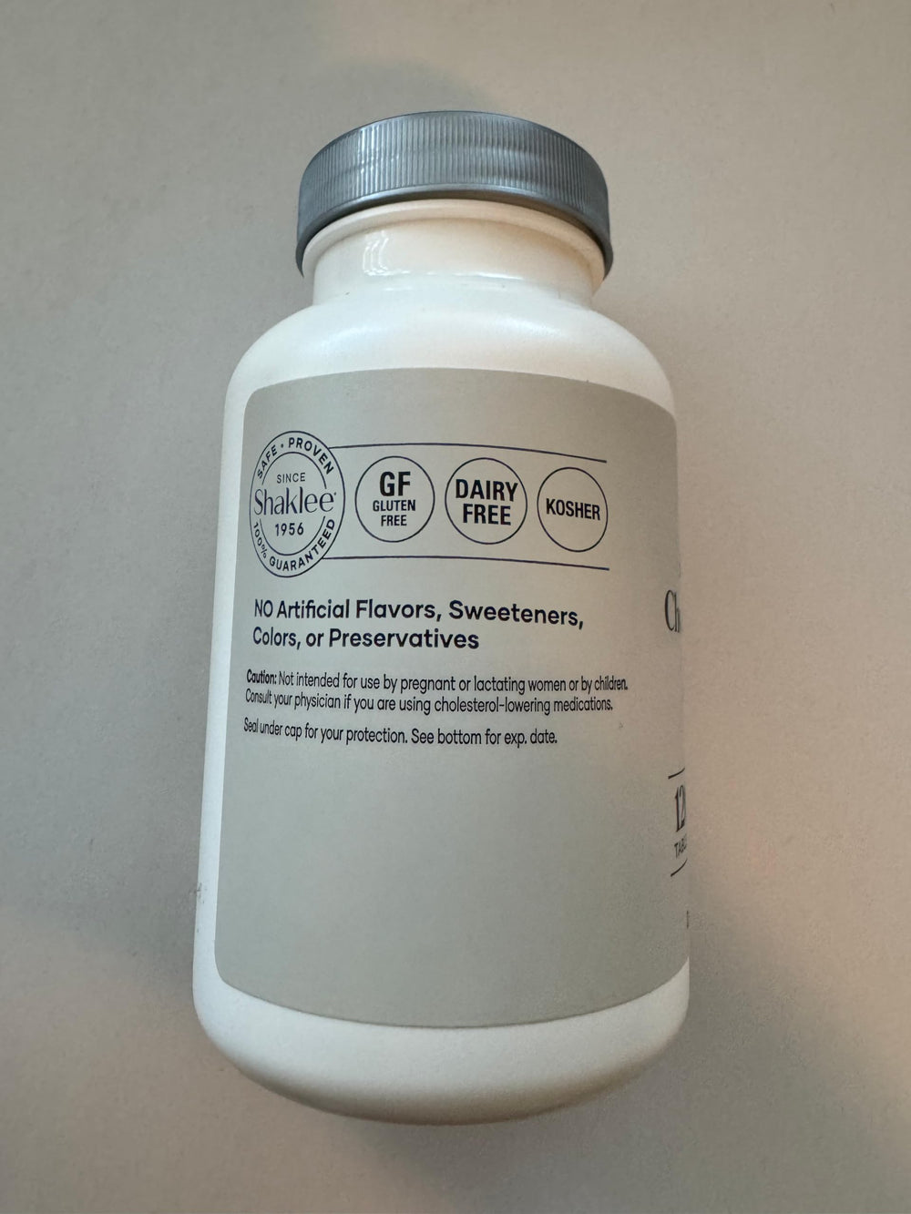 Shaklee Cholesterol Complex bottle with label illustrating a plant-based wellness option