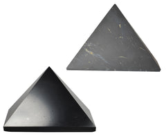 Shungite World 90mm polished pyramid on a desk for subtle energy balance.