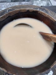 SINGHS kava enjoying a relaxing moment with a warm beverage.