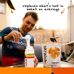 Skratch Labs Hydration Orange powder mixed in water to support endurance workouts.