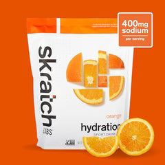 Skratch Labs Hydration Orange tub closeup showing real-fruit powder and clean ingredients.