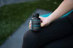 SmarterVitamins Omega-3 daily use scene with bottle and glass of water
