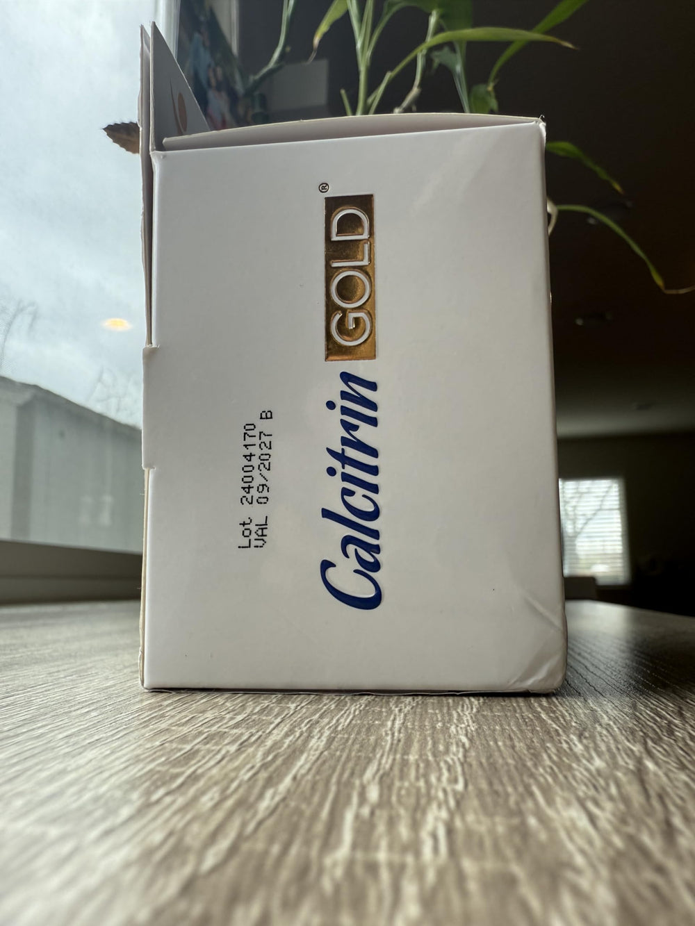 Soy Sano Calcitrin Gold bottle with glass of water for daily intake.