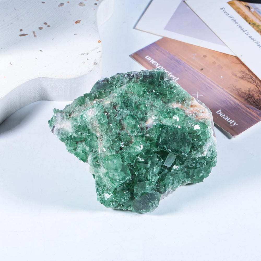 Sportmusies green fluorite cluster on windowsill catches light for calming atmosphere.