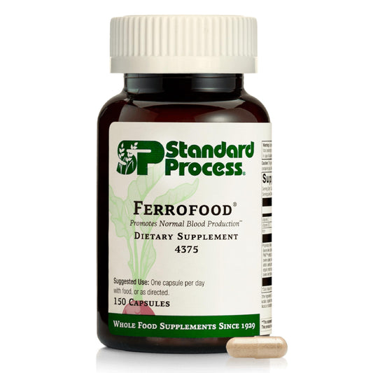 Standard Process Ferrofood bottle on table highlighting iron support for daily blood health.