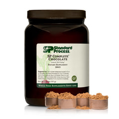 Standard Process SP Complete chocolate canister on shelf; supports muscle health with essential amino acids.