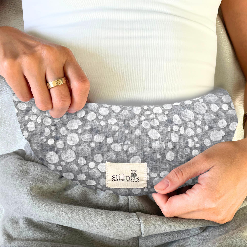 Stillnus Crescent Moon Pillow lavender-filled interior provides calming scent and warmth.
