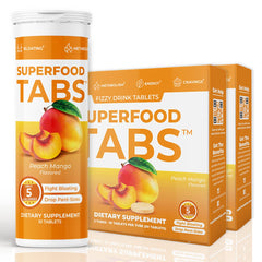 Superfood Tabs Peach Mango effervescent tab dissolving in water for digestion and energy support.