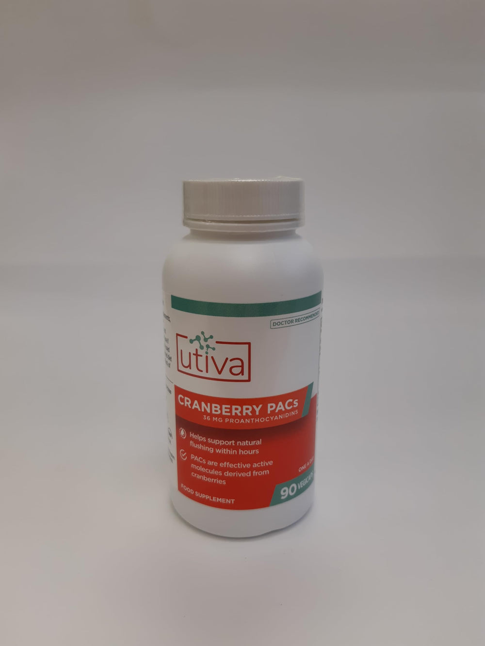 Utiva Cranberry PACs bottle on a countertop with a glass of water.