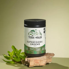 Terra Origin probiotic greens with digestive enzymes spooned for nutrient absorption.