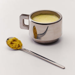 The Nue Co Debloat Gut Barrier+ powder dissolving smoothly in water.