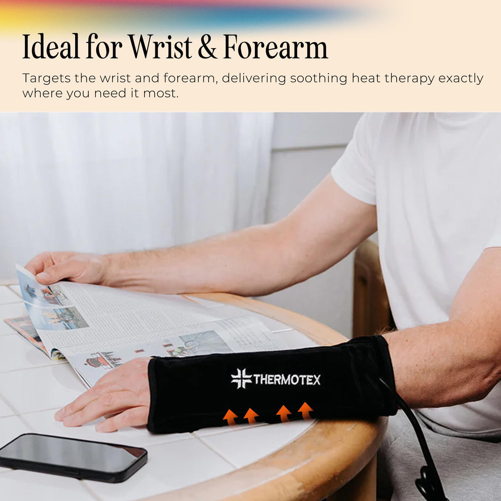 Thermotex left-wrist heating pad in use illustrating secure wrap and targeted warmth.
