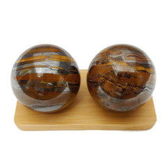Top Chi Tiger Iron Baoding Ball on desk during gentle desk exercises.