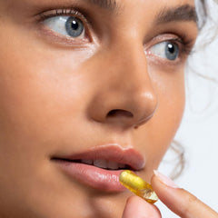 Vida Glow Clear Flawless capsules with a glass of water suggest simple daily intake.
