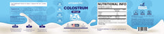Vitamatic Bovine Colostrum Powder bottle beside ingredients under natural light