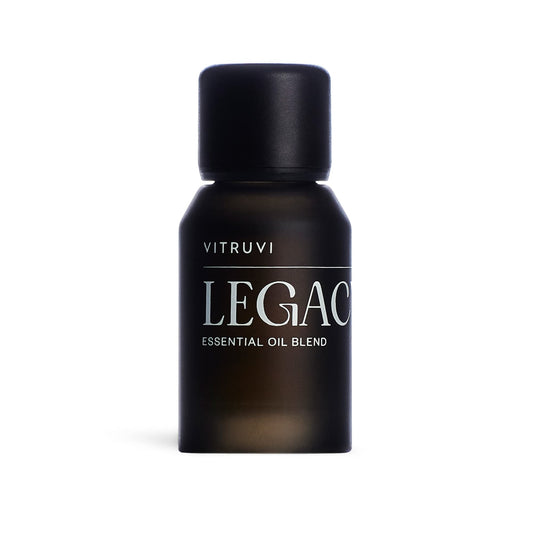Vitruvi Legacy Woodsy Blend bottle highlights rose, bergamot, and cedarwood notes for calming diffusion.