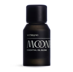 Vitruvi Moonbeam bottle on a wooden surface for a serene, fragrance-rich space.
