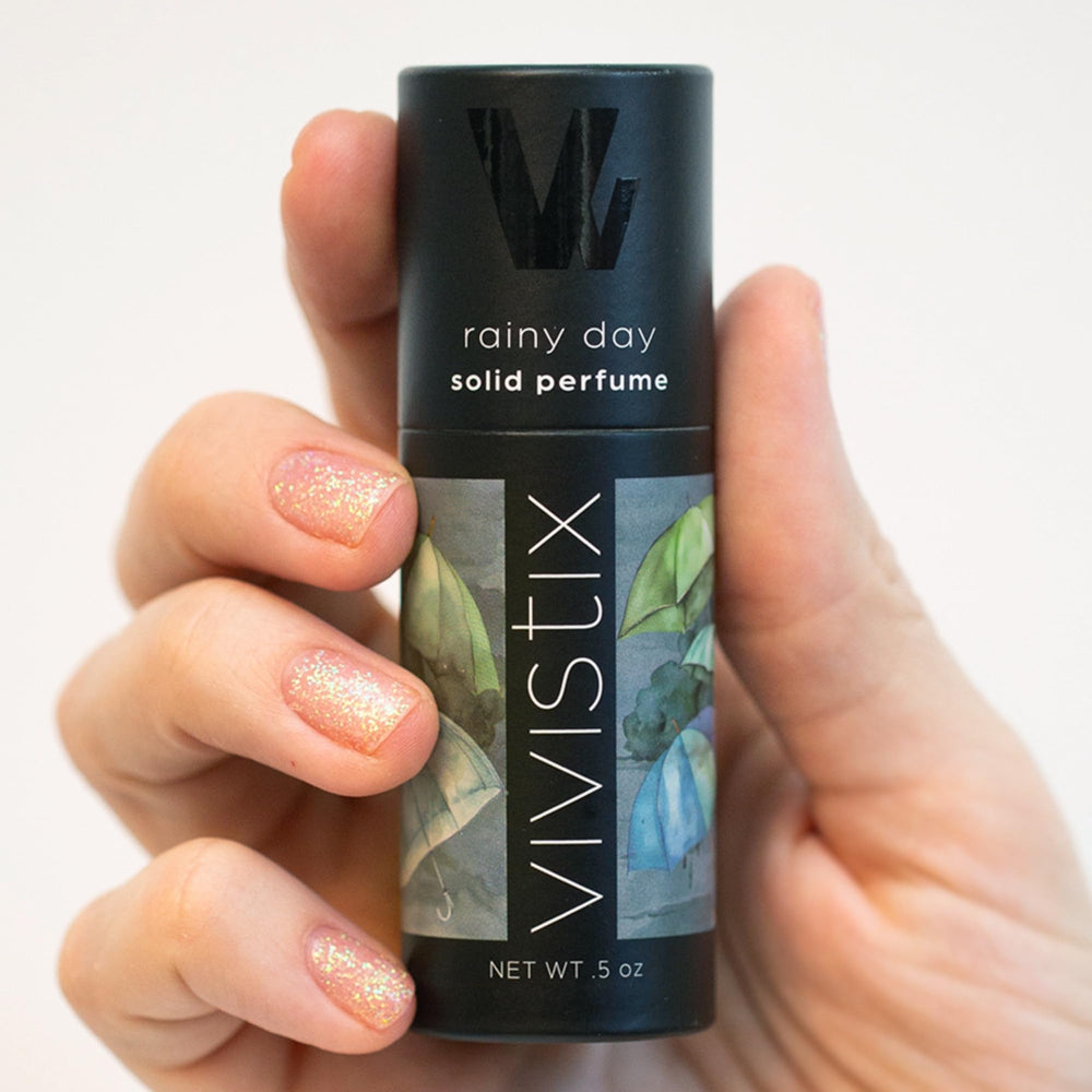 Vivistix solid perfume stick application on wrist for quick refresh.