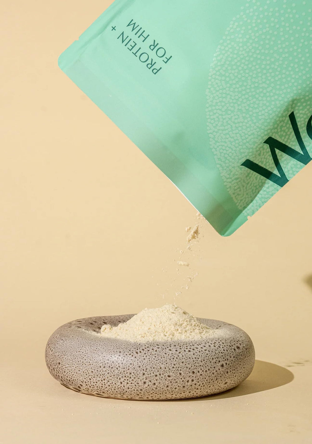 WeNatal Protein for Him bottle packaging shows non-GMO formula for wellness.