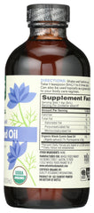 Whole Foods Market pouring black seed oil over spoon for easy daily supplementation