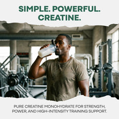 Wild Foods creatine stick packet beside a glass of water for easy mixing.