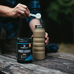 Powder dissolving into water for quick hydration before training, Wilderness Athlete Hydrate & Recover.