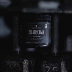 Scoop of Wilderness Athlete Creatine HMB powder ready for a shake.