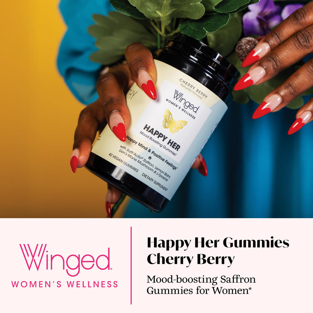 Winged Wellness Happy Her gummies in hand for a simple daily ritual