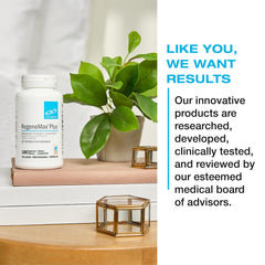 Measuring scoop of OrganiX Reds and Greens over a glass of vibrant juice