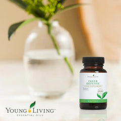 Young Living Inner Defense bottle being poured to show liquid capsule flow.