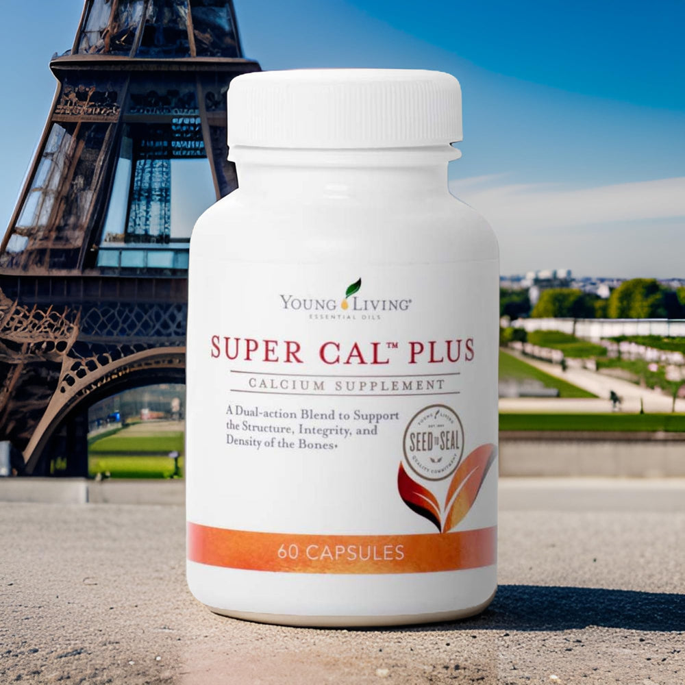 Young Living Super Cal Plus bottle beside a glass of water during morning routine.