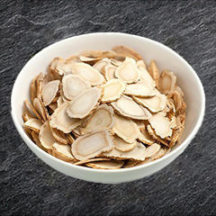 Zen Ginseng slices closeup with amber bottle for daily use