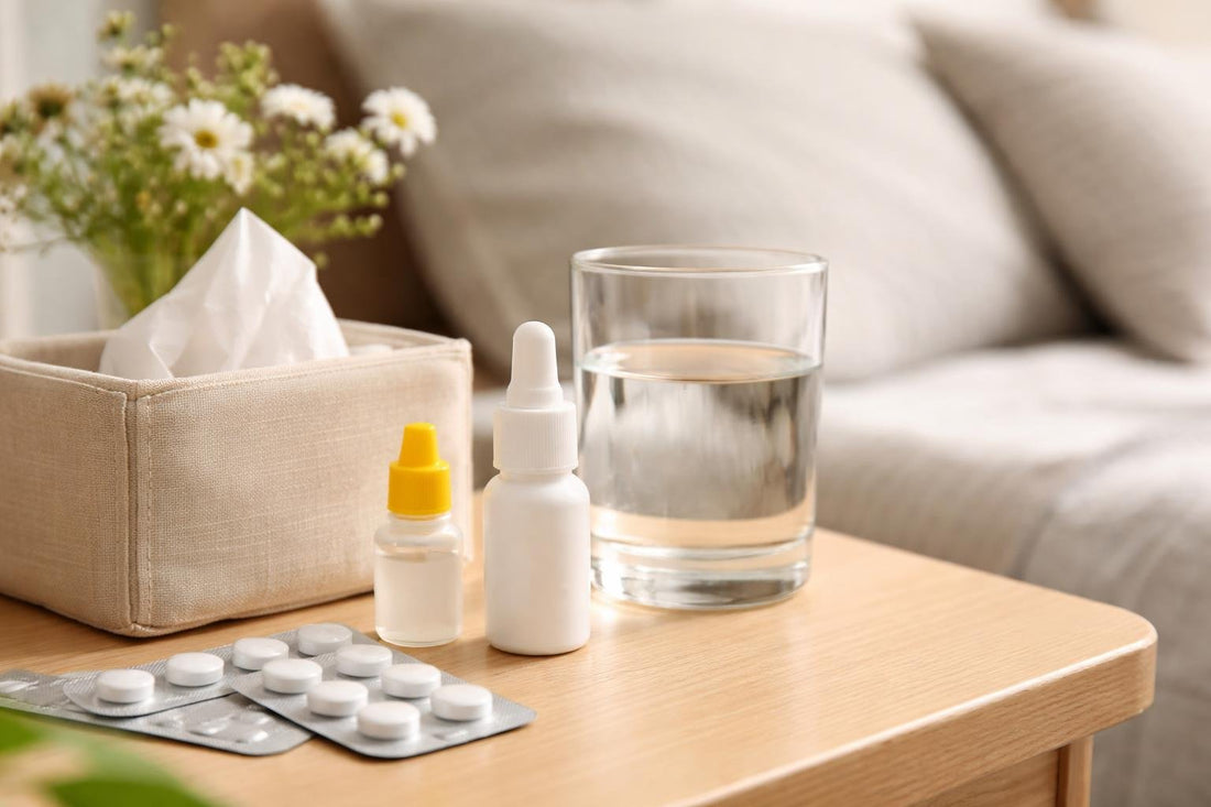 Allergy medicine tablets and nasal spray on a bedside table