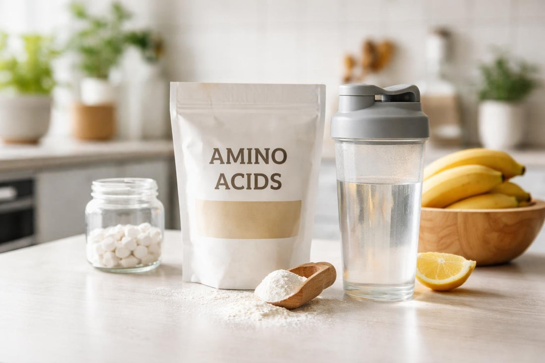 Amino acids supplement powder scoop beside shaker bottle